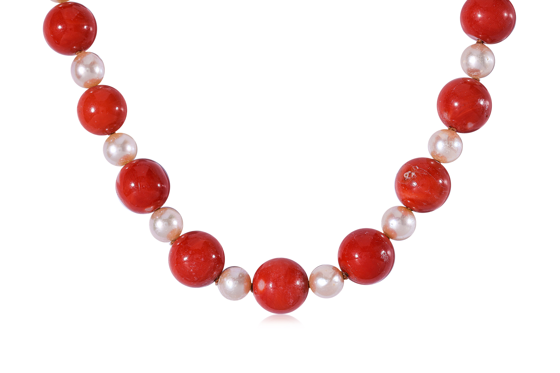 A LONG CORAL AND CULTURED PEARL STRAND ON A MABE PEARL CLASP