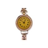 A LADIES GOLD POCKET WATCH ON A BRACELET STRAP