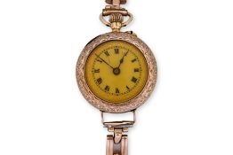 A LADIES GOLD POCKET WATCH ON A BRACELET STRAP