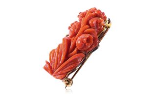 A CARVED RED CORAL 'FLOWER' BROOCH