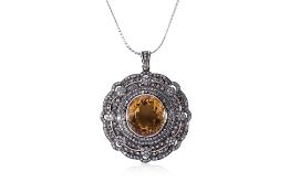 A CITRINE AND DIAMOND PENDANT ON CHAIN