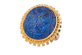 A CARVED LAPIS LAZULI CABOCHON REVIVAL STYLE RING