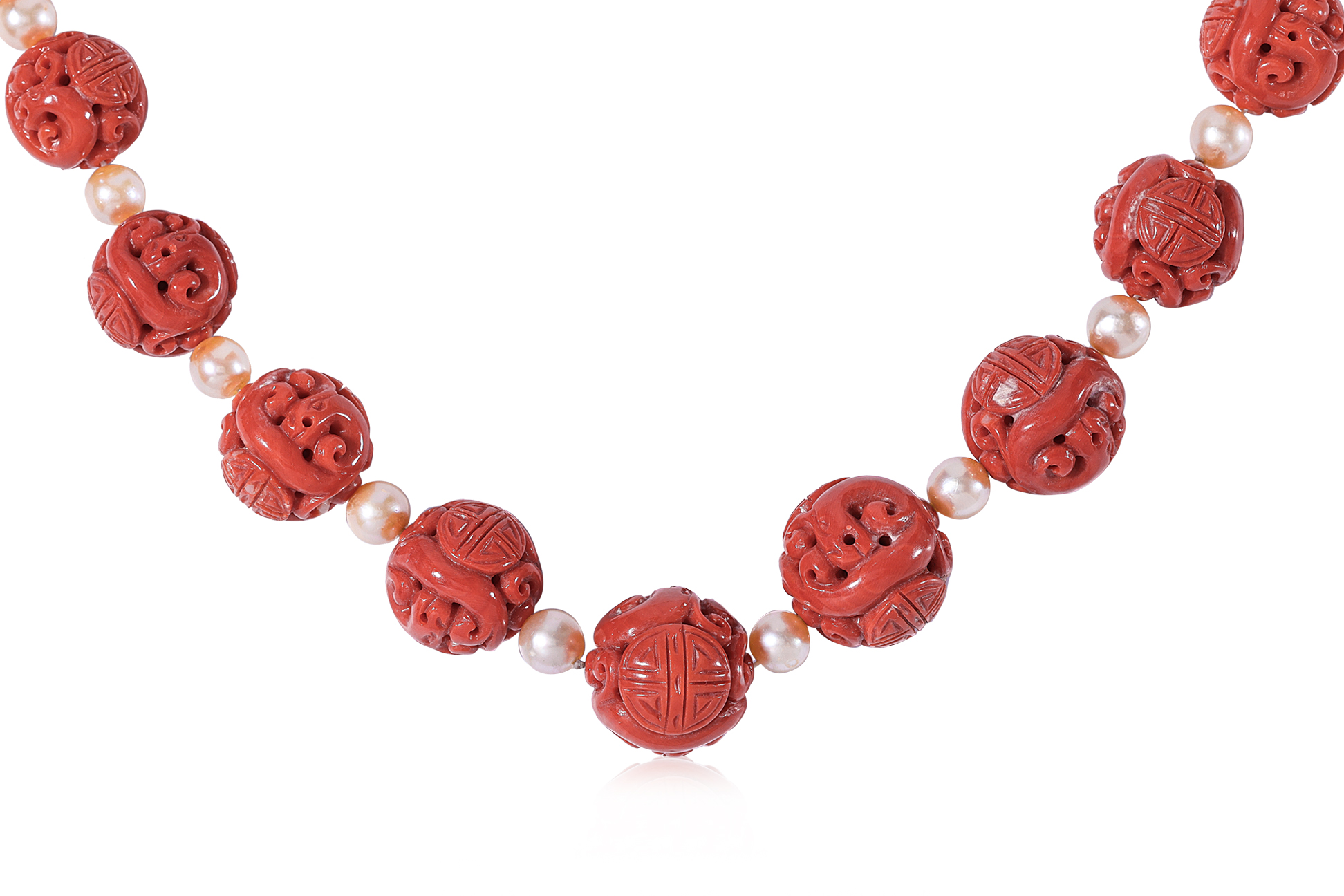 A LONG CARVED CORAL AND CULTURED PEARL NECKLACE