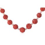 A LONG CARVED CORAL AND CULTURED PEARL NECKLACE