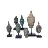 A GROUP OF SEVEN VARIOUS BUDDHA HEADS