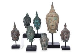 A GROUP OF SEVEN VARIOUS BUDDHA HEADS