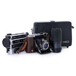 A ZEISS IKON FOLD-OUT CAMERA, A TOKINA LENS AND A SUPER 8