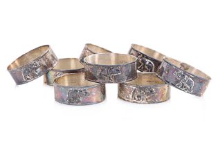 A SET OF EIGHT ELEPHANT DECORATED SILVER NAPKIN RINGS