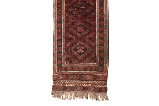 A SMALL TRIBAL WOOL RUNNER