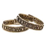 A PAIR OF REPOUSSE SILVER BANGLES