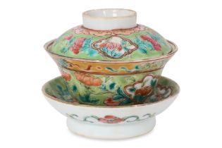 A FAMILLE ROSE GREEN GROUND TEA BOWL, COVER AND STAND