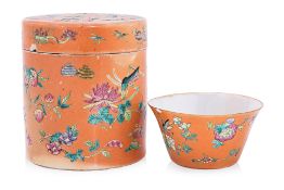 A FAMILLE ROSE CORAL GROUND COVERED BOX AND TEA CUP