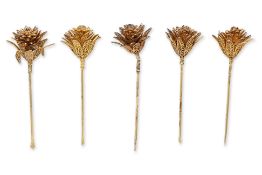 A GROUP OF FIVE SILVER FLOWER-SHAPED HAIRPINS