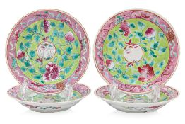 A GROUP OF FOUR LIME GREEN GROUND FAMILLE ROSE SAUCERS