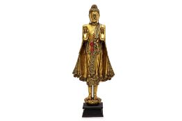 A THAI STATUE OF BUDDHA STANDING