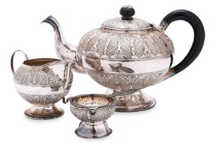 A MALAYSIAN SILVER TEAPOT; MILK JUG AND STRAINER ON STAND