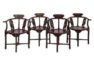 A SET OF 4 CARVED HARDWOOD CORNER CHAIRS