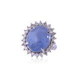 A CABOCHON BLUE STAR SAPPHIRE AND DIAMOND 'HALO' RING