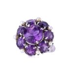 AN AMETHYST AND SEED PEARL FLOWERHEAD RING