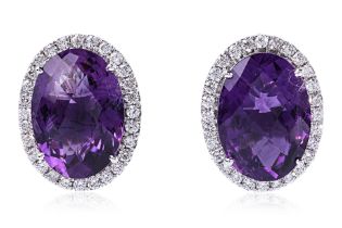 A PAIR OF AMETHYST AND DIAMOND STUD EARRINGS