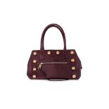 A MARC JACOBS BURGUNDY LEATHER BAG WITH GOLD STUD ACCENTS