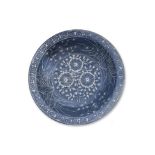 A LARGE SWATOW SLIP-DECORATED BLUE GROUND BOWL