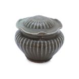 A LONGQUAN CELADON RIBBED JAR WITH LOTUS LEAF COVER
