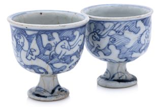 TWO SIMILAR BLUE AND WHITE PORCELAIN STEM CUPS
