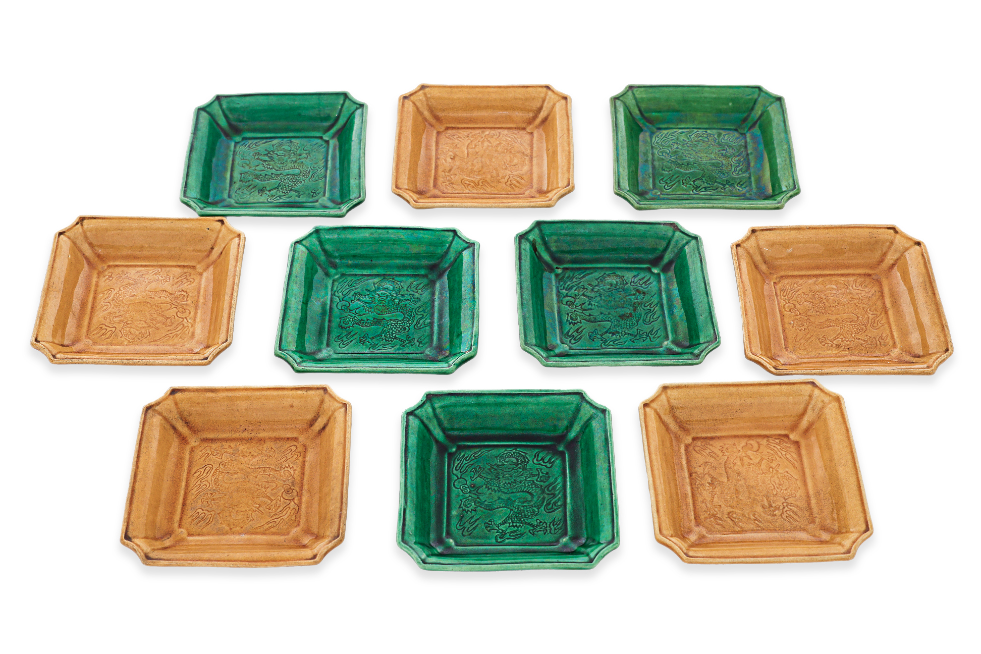 A GROUP OF TEN SMALL GREEN AND YELLOW GLAZED DRAGON DISHES