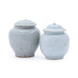 TWO SMALL MOULDED QINGBAI JARS AND COVERS