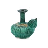 A GREEN GLAZED FLUTED AND MOULDED DRAGON KENDI