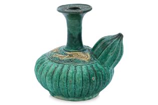 A GREEN GLAZED FLUTED AND MOULDED DRAGON KENDI