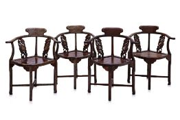 A SET OF FOUR CARVED HARDWOOD CORNER CHAIRS