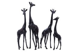 A GROUP OF FOUR AFRICAN CARVED HARDWOOD GIRAFFES
