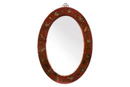 A RED LACQUERED OVAL MIRROR