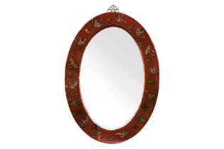 A RED LACQUERED OVAL MIRROR