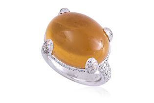 A YELLOW STONE AND DIAMOND RING