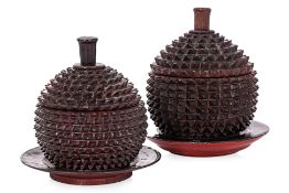 A PAIR OF WOODEN DURIAN FORMED JARS WITH COVERS