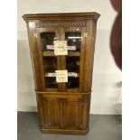 An oak corner cabinet with lighting & a side table