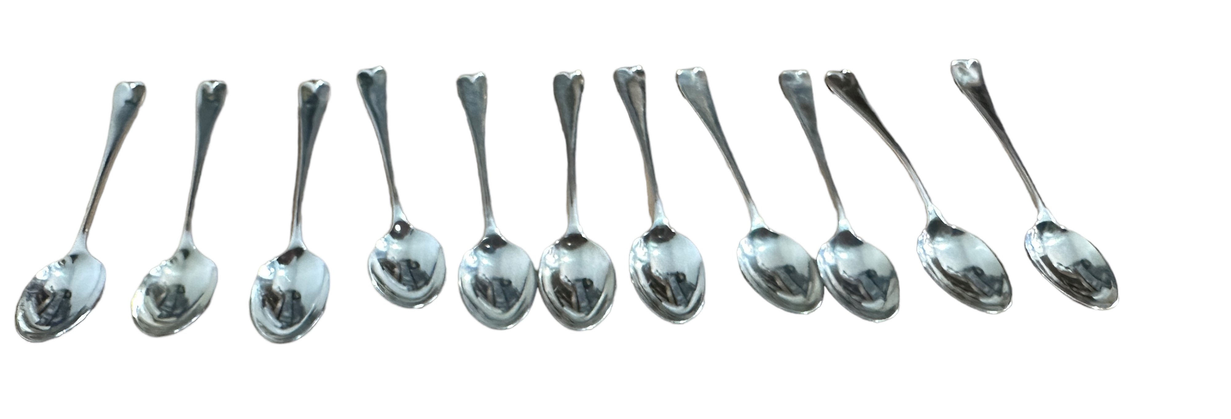 Lot of 11 Silver Spoons with decorated back of bowls - 12.5cm long.