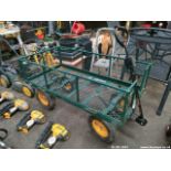 A FOUR WHEELED GARDEN TROLLEY ON PNEUMATIC TYRES