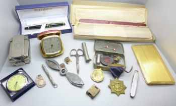 A Waterman ink pen, a slab of Superfine Sealing Wax, travel clock, tin of medallions, plated