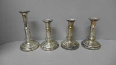 Four plated candlesticks, weighted