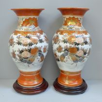 A pair of Japanese Kutani vases on stands, 29.5cm