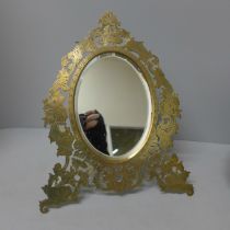 A circa 1900 mirror with brass frame and bevelled mirror, 30cm