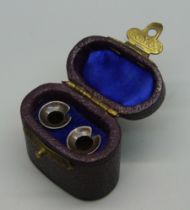 A pair of Victorian white metal hearing aid ear pieces, boxed