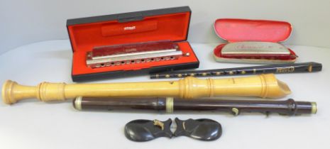 Musical instruments; a Larry Adler Professional 16 harmonica, one other, tin whistle, recorder,