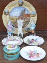 Two continental figures, a crested china longcase clock, a German cabinet plate, a Spanish lidded