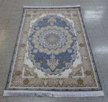 An Iranian beige ground rug, 190cm x 121cm