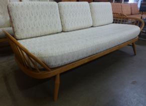 An Ercol Blonde ash and beech 355 model studio couch. Purchased by the vendor from Hopewells,